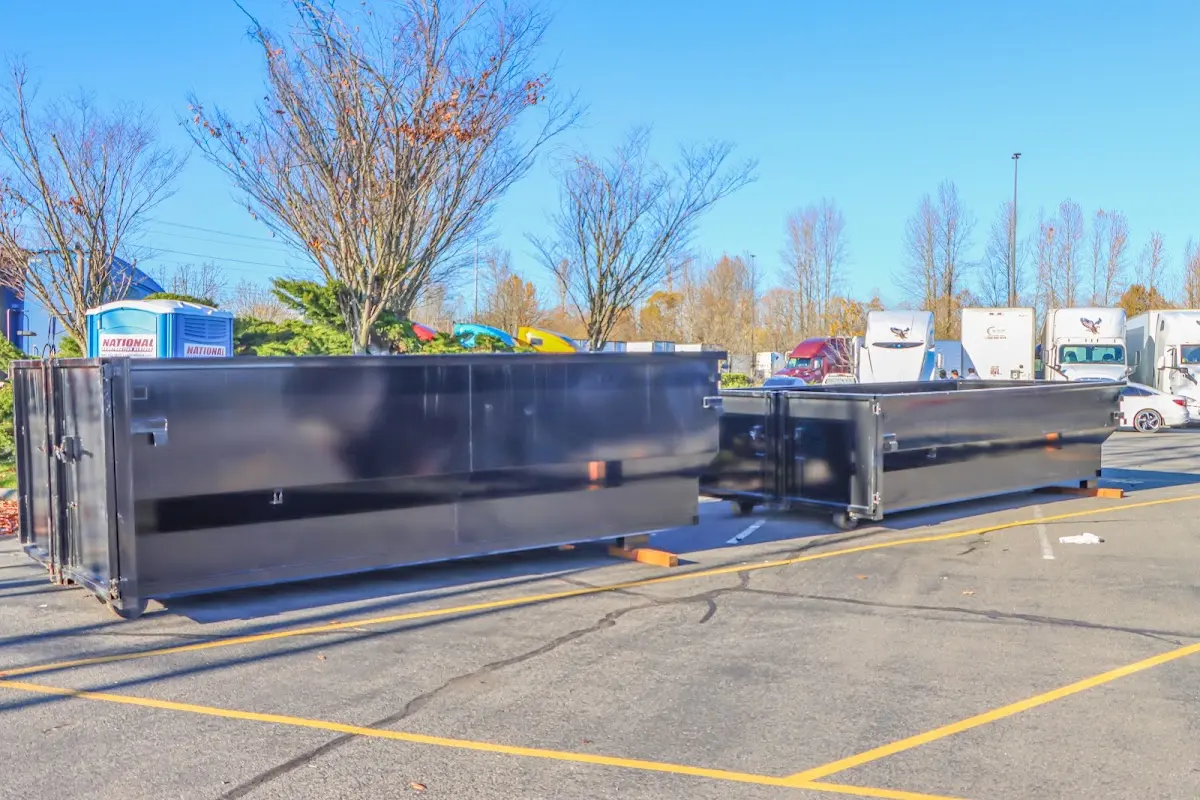 Professional dumpster rental service with roll-off container on residential driveway in Mitchellville